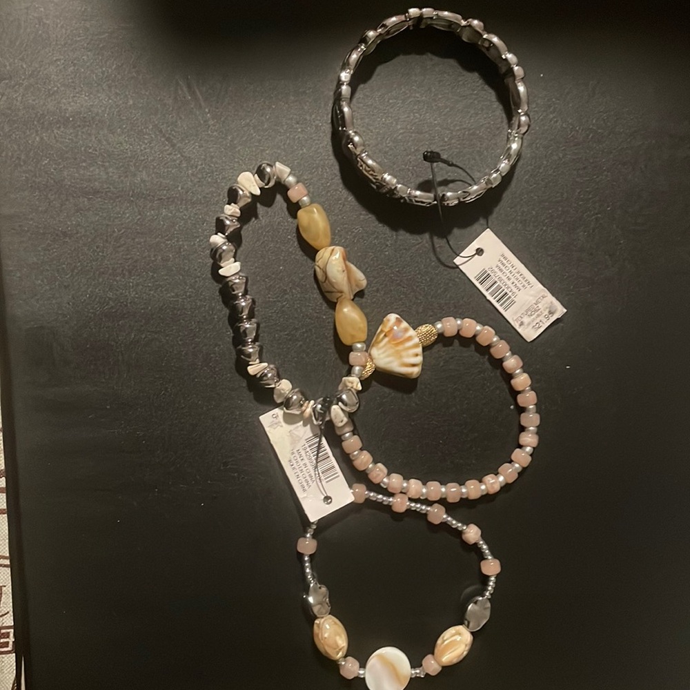 4 bracelets total. 3 are beach theme and one is metal color.